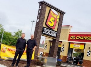 Take 5 franchise owners standing outside their Take 5 location. 